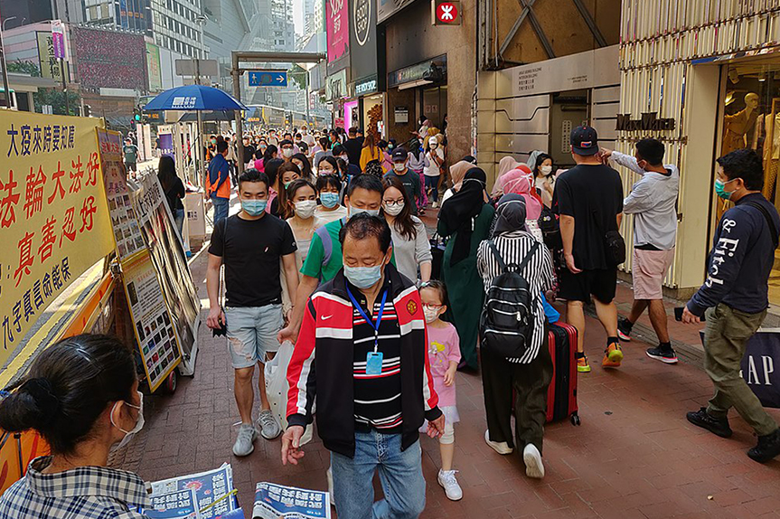 Pandemic Overreach; Shoppers in Hong Kong wearing masks during the COVID-19 pandemic, March 2020. (Andrii Makukha/Wikimedia)