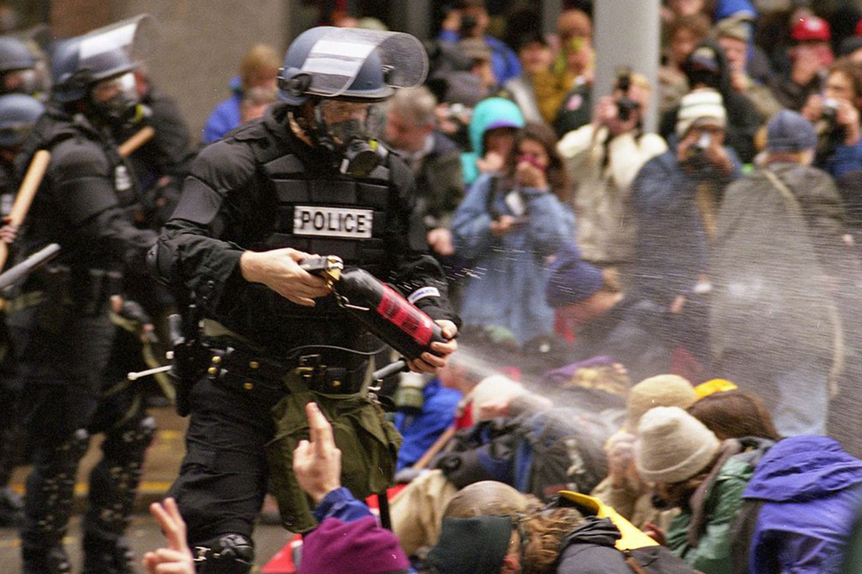 WTO protests in Seattle, November 30, 1999 Pepper spray is applied to the crowd. (Photo: Steve Kaiser/Creative Commons)