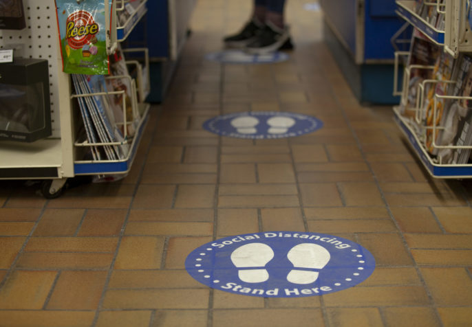 Social distancing sign at drugstore (Photo: GoToVan/Flickr)