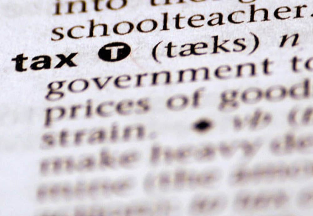 501c3-tax-image Closeup of a dictionary entry for the word tax