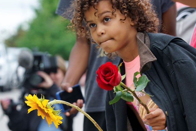 protecting the Right to Protest; little girl with rose and sunflower in hand