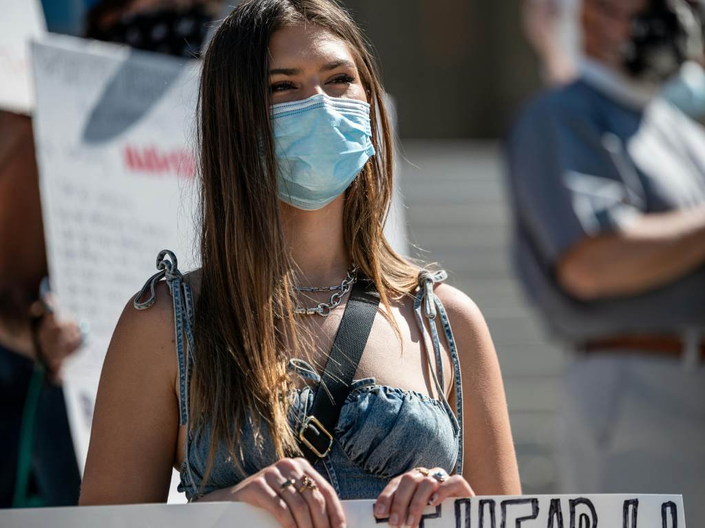 Young woman in mask protesting on street by Brett Sayles from Pexels
