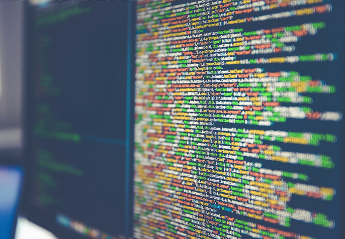 Colorful code on computer monitors (Photo: Markus Spiske/Unsplash)