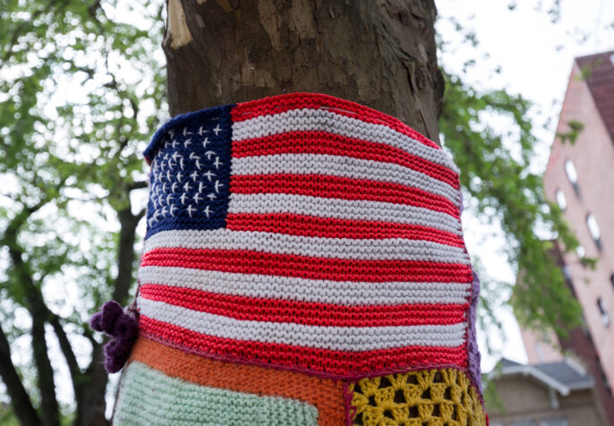 American flag crocheted around a tree in a Brooklyn Park. (Photo: Andriy Prokopenko/Getty)