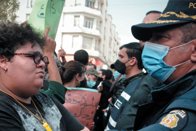 Tunisian women staring at masked Tunisian police (photo credit: shutterstock.com)