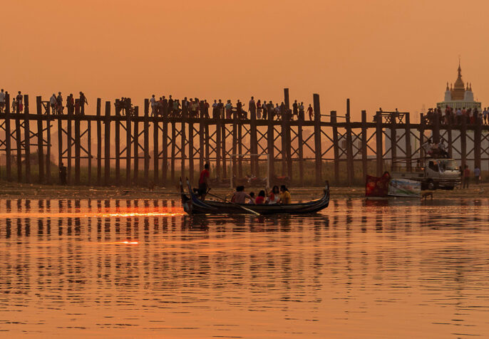 A river and bridge at sunset in Myanmar