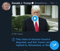 A screenshot of Donald Trump tweet from January 6, 2021 that shows a clip of his video expressing false information about the 2020 US Presidential Election. The tweet has a disclaimer under it from Twitter that reads: "This claim of election fraud is disputed, and this tweet can't be replied to, retweeted, or liked."