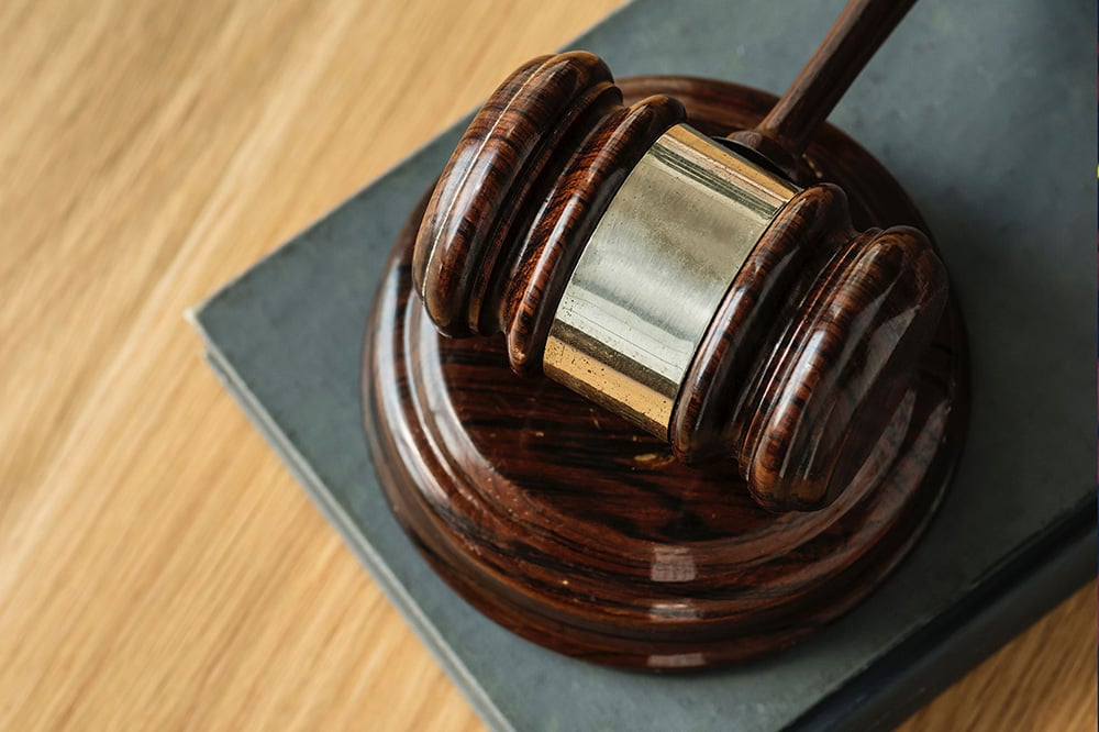 textbook for civil society organizations; Judges gavel laying on wood table (Photo credit: Rawpixel/Unsplash)