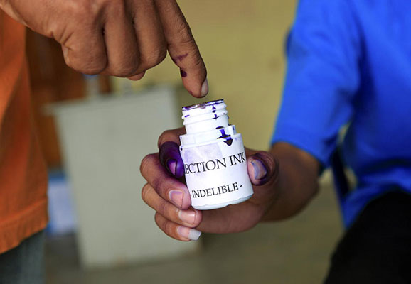 A voter dips his finger in indelible ink before casting his vote during the Second National Village Council (sucos) elections of 9 October in Dili, Timor-Leste. The elections, which are supervised by the United Nations Integrated Mission in Timor-Leste (UNMIT), are held simultaneously in 442 sucos across the country. Candidates are vying for positions as village chiefs and members of village councils for the first time since the first round of village elections in 2004 and 2005. 9/Oct/2009. Dili, Timor-Leste (photo credit: UN Photo/Martine Perret)