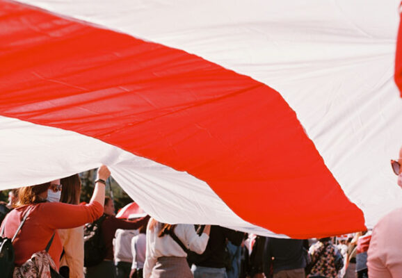 Crowd Carrying Belarus flag (photo credit: unsplash.com)