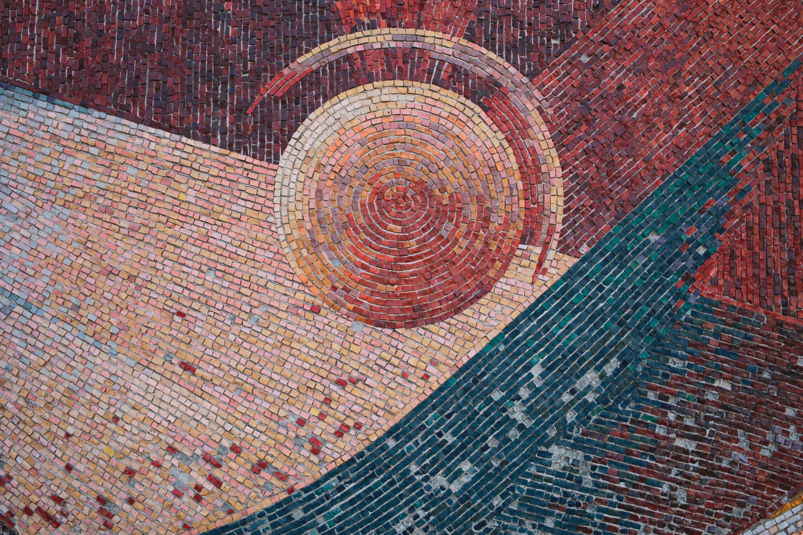 Brick wall mosaic, photo by Andrey K via unsplash