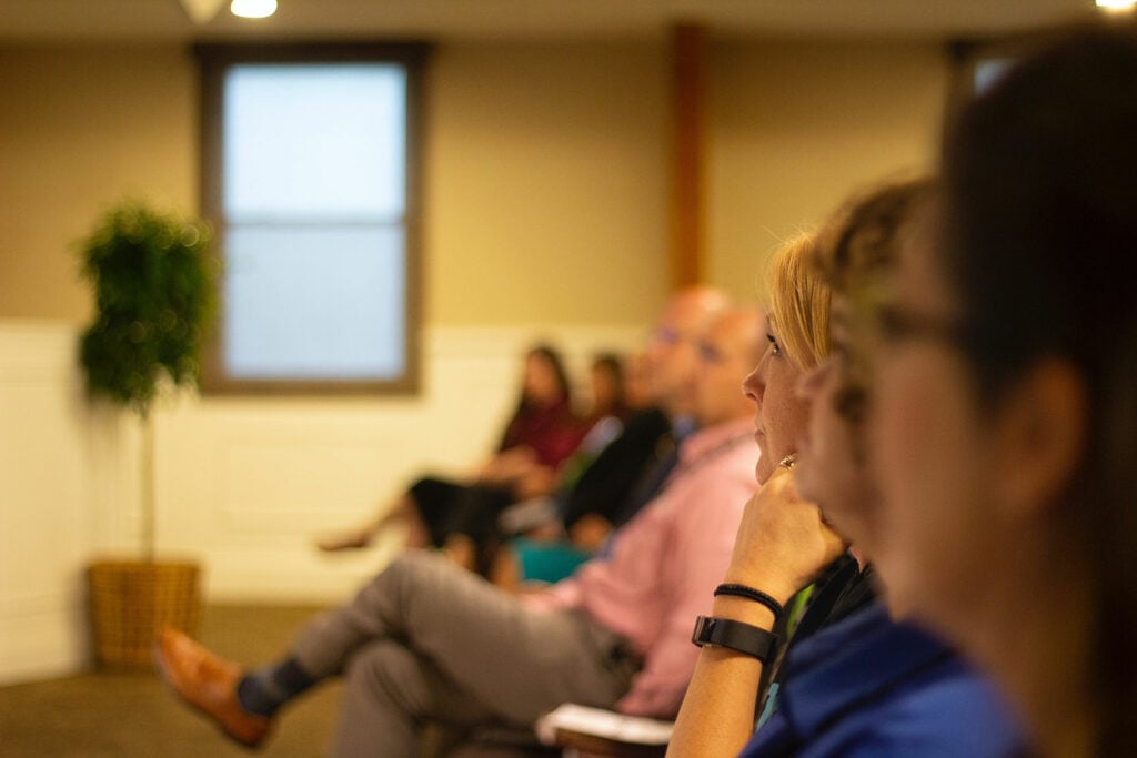 people listening to a speaker make an announcement; Regulation of civil society organizations.