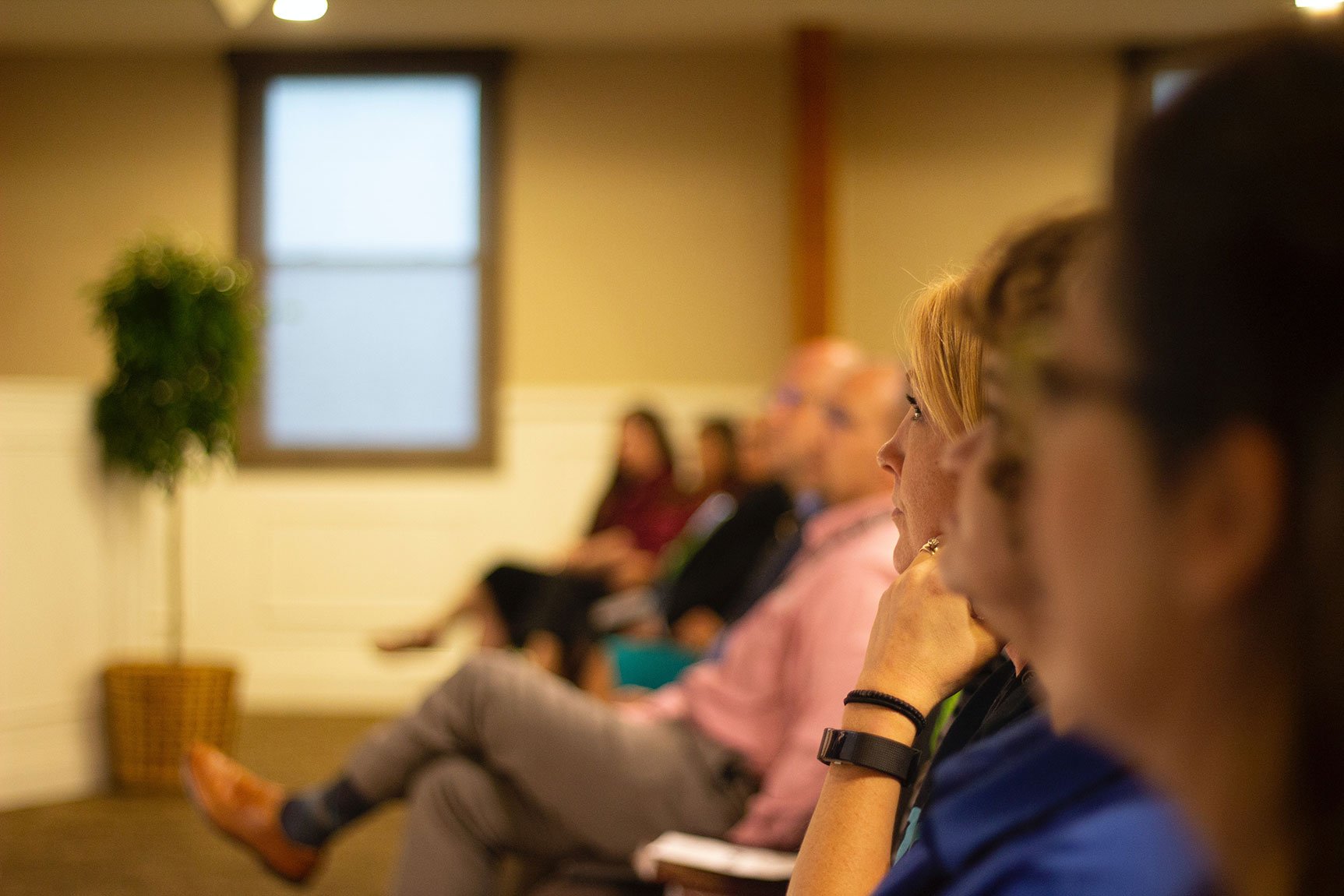 people listening to a speaker make an announcement