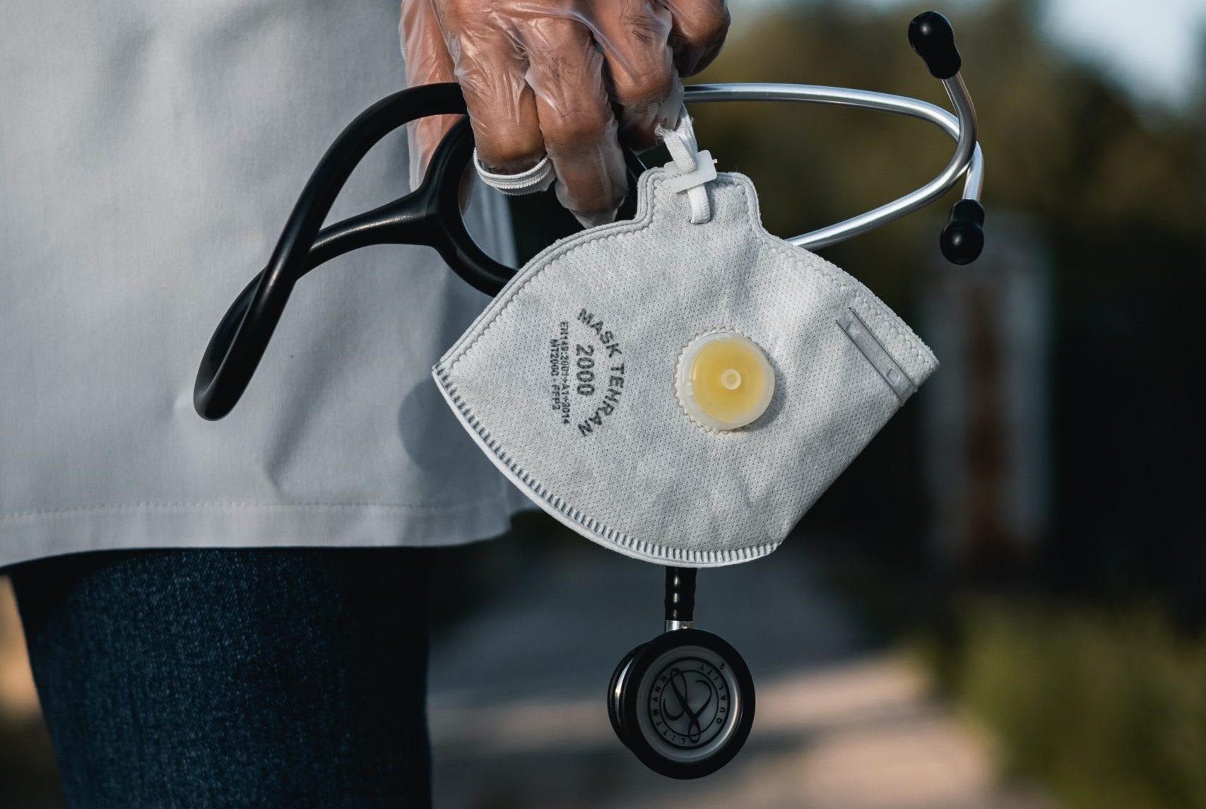 doctor with mask in hands (photo credit: unsplash.com)