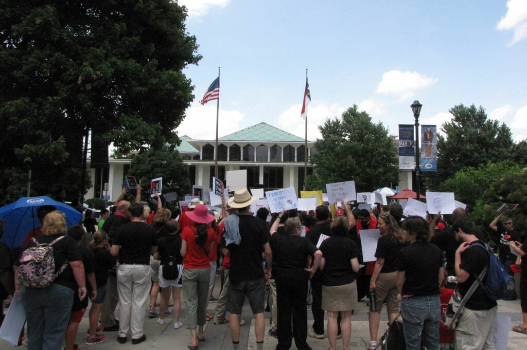 people protesting at a capital building. Restrictions on Protests at Statehouses.