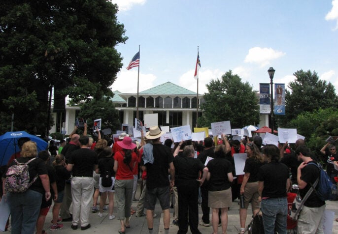 people protesting at a capital building.