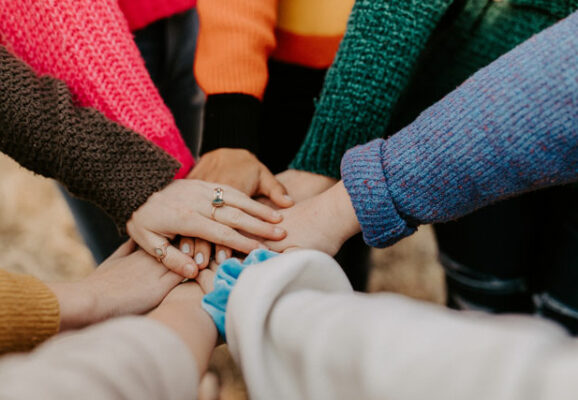 Group of women touching hands (photo credit: unsplah.com)