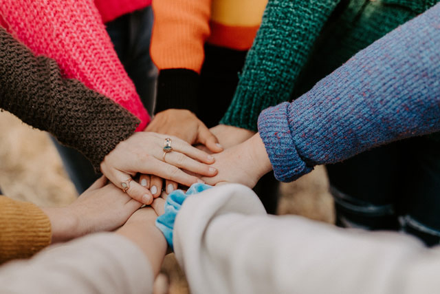 Group of women touching hands (photo credit: unsplah.com)