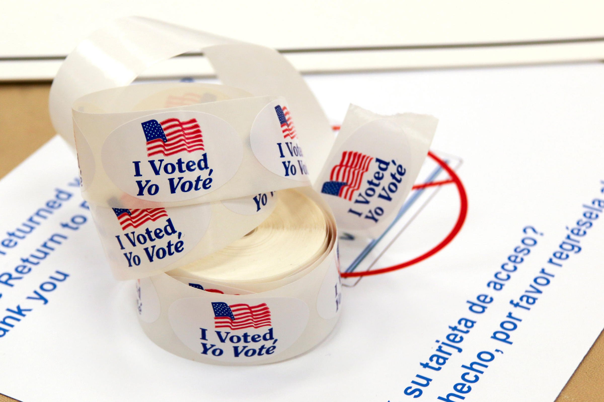 'I Voted' sticker spool on top of a ballot envelope. Stickers have an American flag on them and are in English and Spanish. (GPA PHOTO ARCHIVE/Flickr)