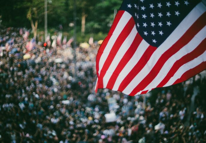 Litigation Challenging Anti-Protest Laws; An american flag with protesters.