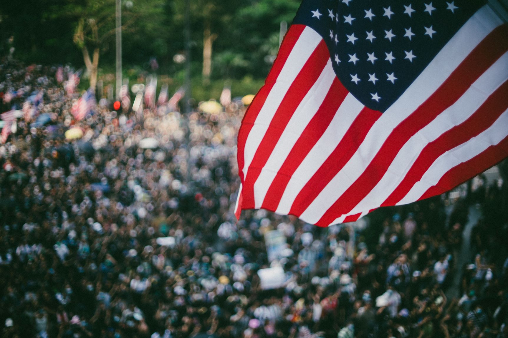 Litigation Challenging Anti-Protest Laws; An american flag with protesters.