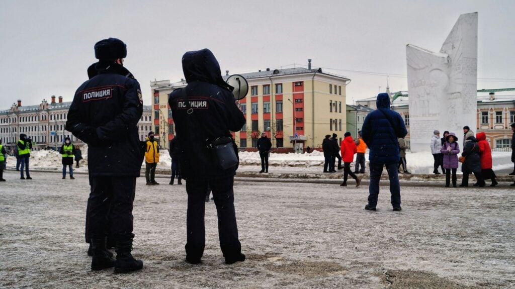 Police overseeing crowd in Russia. Photo by Kirill Kruglikov via Unsplash