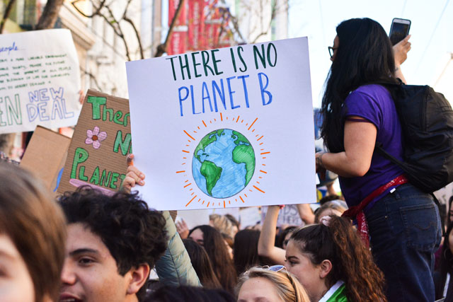 Young climate activists protesting with sign. Sign text: "There is no planet B" (photo credit: unsplash.com)