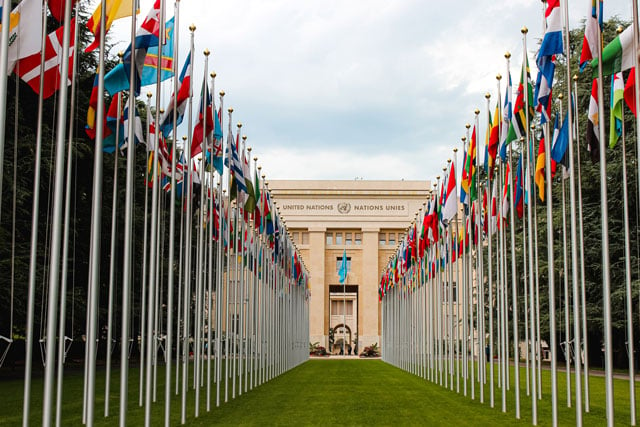 United Nations headquarters with flags (credit: unsplash.com):