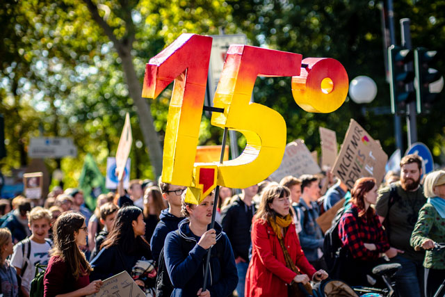 climate activists in crowd with sign that says 1.5 degrees (photo credit: unsplash.com)