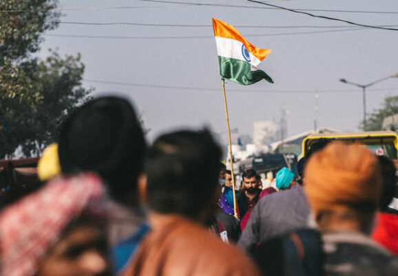 Farmers protesting holding India flag (photo credit: unsplash.com)