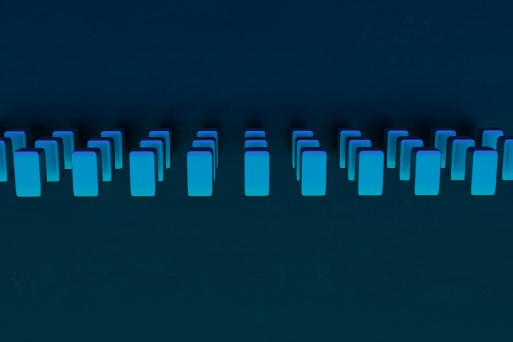 Series of blue rectangles in groups of three over dark blue background. 3d render by Steve Johnson via unsplash